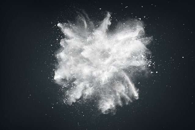 Abstract design of white powder cloud against dark background